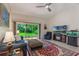Comfortable living area featuring a sliding door to the backyard and a large television at 414 Long Cove Ct, Ormond Beach, FL 32174