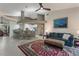 Open living room featuring a comfortable blue sofa, patterned rug, and view into the kitchen at 414 Long Cove Ct, Ormond Beach, FL 32174
