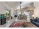 Bright living room featuring an open layout, adjacent dining area, and bar seating at 414 Long Cove Ct, Ormond Beach, FL 32174