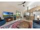 Spacious living area with a fireplace, mounted television, and a view into the dining area and kitchen at 414 Long Cove Ct, Ormond Beach, FL 32174