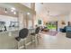 Open-concept living room with access to kitchen bar and view of backyard at 414 Long Cove Ct, Ormond Beach, FL 32174