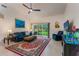 Cozy living area featuring comfortable seating, a large window, and a mounted television at 414 Long Cove Ct, Ormond Beach, FL 32174