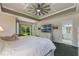 Spacious main bedroom featuring tray ceilings, white furniture and an en-suite bathroom at 414 Long Cove Ct, Ormond Beach, FL 32174