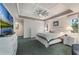 Spacious main bedroom featuring tray ceilings, white furniture and an en-suite bathroom at 414 Long Cove Ct, Ormond Beach, FL 32174