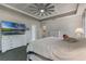 Spacious main bedroom featuring tray ceilings, white furniture and an en-suite bathroom at 414 Long Cove Ct, Ormond Beach, FL 32174