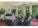 Covered patio with comfortable seating and views of the landscaped backyard at 414 Long Cove Ct, Ormond Beach, FL 32174