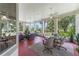 Bright sunroom features tile floors, ceiling fans and sliding windows with views of the landscaped yard at 414 Long Cove Ct, Ormond Beach, FL 32174