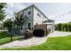 This backyard is complete with a grill, covered patio with ample seating, and string lights for elegant evenings at 5095 Southlawn Ave, Orlando, FL 32811