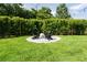 Spacious backyard featuring a circular fire pit area and green lawn bordered by bamboo fencing for privacy at 5095 Southlawn Ave, Orlando, FL 32811