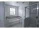 Bathroom features a bathtub, a glass-walled shower, and neutral-toned tile flooring at 5095 Southlawn Ave, Orlando, FL 32811