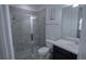 Bathroom with a tiled shower and a dark vanity with a light countertop at 5095 Southlawn Ave, Orlando, FL 32811