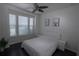 Cozy bedroom with a large window, a ceiling fan and dark wood floors at 5095 Southlawn Ave, Orlando, FL 32811