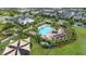 Aerial view of the community pool, pool house, playground, and lush landscaping in the Millenia Park Community at 5095 Southlawn Ave, Orlando, FL 32811