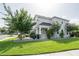 Home featuring a covered porch, a spacious green lawn and mature trees at 5095 Southlawn Ave, Orlando, FL 32811