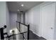 Hallway with several doors and black railings and a stairwell at 5095 Southlawn Ave, Orlando, FL 32811
