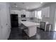 Bright kitchen with white cabinets, stainless steel appliances, a center island and dark wood floors at 5095 Southlawn Ave, Orlando, FL 32811