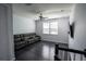 Spacious living room featuring a large sofa and a mounted television at 5095 Southlawn Ave, Orlando, FL 32811