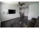 Living room with mounted TV and an oversized sectional couch at 5095 Southlawn Ave, Orlando, FL 32811