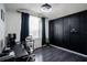 Modern office with a large desk and a panelled black accent wall at 5095 Southlawn Ave, Orlando, FL 32811