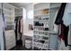 Bright walk-in closet features custom shelving, drawers, and a vanity area with a round window at 5095 Southlawn Ave, Orlando, FL 32811