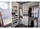 Bright walk-in closet boasts adjustable shelves, closet rods, vanity with a round window, drawers for optimized storage at 5095 Southlawn Ave, Orlando, FL 32811