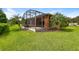 Picture of a spacious backyard featuring a screened-in patio and lush green grass perfect for outdoor enjoyment at 154 Indian Wells Ave, Kissimmee, FL 34759