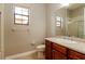 Functional bathroom with a tile floor, wood vanity, and shower and tub combo at 154 Indian Wells Ave, Kissimmee, FL 34759