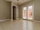 Inviting bedroom with tiled flooring and access to the outside through glass doors at 154 Indian Wells Ave, Kissimmee, FL 34759