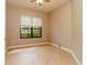 Comfortable bedroom with tile flooring and a large window offering natural light at 154 Indian Wells Ave, Kissimmee, FL 34759