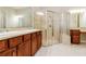 Main bathroom featuring a glass shower, dual sinks, and vanity area at 154 Indian Wells Ave, Kissimmee, FL 34759