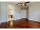 Spacious main bedroom with hardwood floors, a ceiling fan, and an en-suite bathroom at 154 Indian Wells Ave, Kissimmee, FL 34759