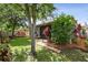 Manicured backyard featuring lush landscaping and brick-lined pathway at 1553 Amber Leaf Cir, Ocoee, FL 34761
