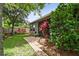 Landscaped backyard with brick walkway and colorful foliage at 1553 Amber Leaf Cir, Ocoee, FL 34761