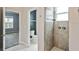 Bathroom featuring tiled shower with glass door, white marble floors, and a modern toilet at 1553 Amber Leaf Cir, Ocoee, FL 34761