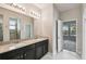Bright bathroom with dual sinks, granite countertop and a tile shower at 1553 Amber Leaf Cir, Ocoee, FL 34761
