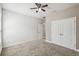 Cozy bedroom with neutral walls, carpet floors, a ceiling fan and closet for ample storage at 1553 Amber Leaf Cir, Ocoee, FL 34761