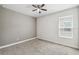 Bedroom with neutral walls, carpet floors, a ceiling fan, and a window providing natural light at 1553 Amber Leaf Cir, Ocoee, FL 34761
