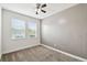Bright bedroom with neutral walls, carpet floors, and two windows providing plenty of natural light at 1553 Amber Leaf Cir, Ocoee, FL 34761