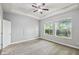 Bright bedroom with natural light, gray walls, and ceiling fan at 1553 Amber Leaf Cir, Ocoee, FL 34761