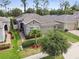 Charming home exterior with stone accents, well-maintained lawn, and mature trees at 1553 Amber Leaf Cir, Ocoee, FL 34761