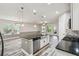 Open kitchen layout with stainless steel appliances, a central island, and wood flooring at 1553 Amber Leaf Cir, Ocoee, FL 34761