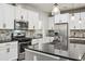 Well-equipped kitchen with stainless appliances, a center island, and stylish backsplash at 1553 Amber Leaf Cir, Ocoee, FL 34761
