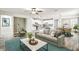 Inviting living room with modern decor, open kitchen, and dining area perfect for entertaining at 1553 Amber Leaf Cir, Ocoee, FL 34761