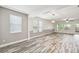 Bright, expansive living room with large windows, stylish floors and contemporary lighting at 1553 Amber Leaf Cir, Ocoee, FL 34761