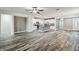 Open-concept living room showcasing modern kitchen with stainless steel appliances and spacious wood-style flooring at 1553 Amber Leaf Cir, Ocoee, FL 34761