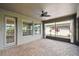 Enclosed patio with brick flooring, ceiling fan, and views of the well-maintained landscaping at 1553 Amber Leaf Cir, Ocoee, FL 34761