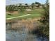 Picturesque community pond and green space with walking path at 1553 Amber Leaf Cir, Ocoee, FL 34761