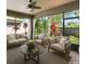 The sunroom has cozy couches and beautiful outdoor views at 1553 Amber Leaf Cir, Ocoee, FL 34761