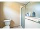 Bathroom featuring a tiled shower with glass door and a low-flow toilet at 17567 Se 81St Parnassus Ct, The Villages, FL 32162