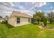 Exterior view of home featuring a well-manicured lawn and an enclosed sunroom at 17567 Se 81St Parnassus Ct, The Villages, FL 32162